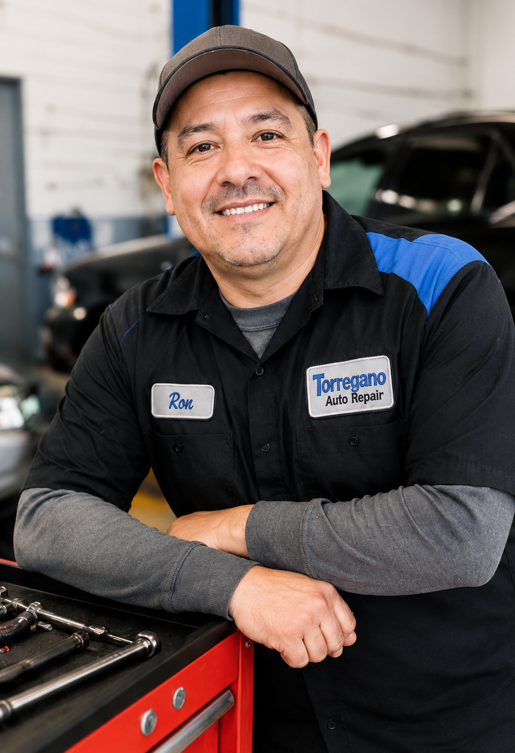 Ron from Torregano Auto Repair standing beside toolbox